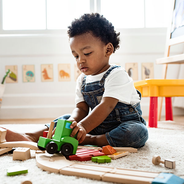 Child Playing with Toy Truck