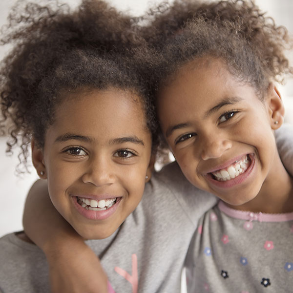 Two sisters hugging each other